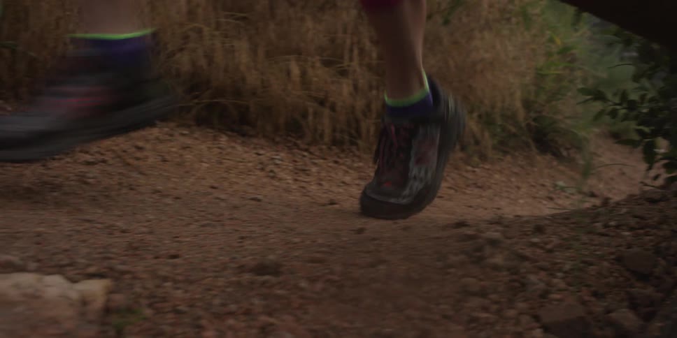 A woman jogging on a dirt path