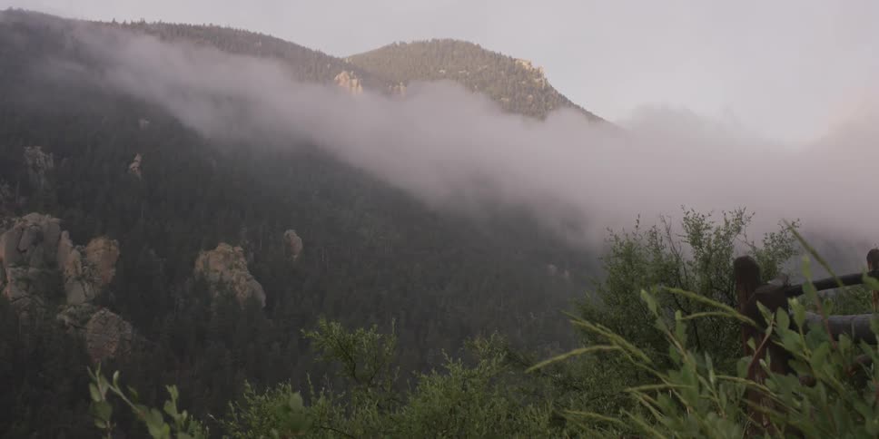 View of a high mountain poking out of the clouds