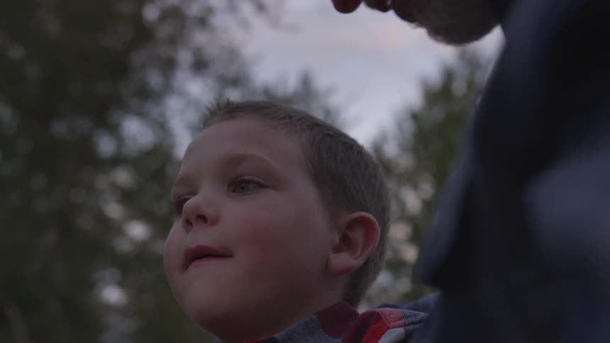Father and son talking on the forest