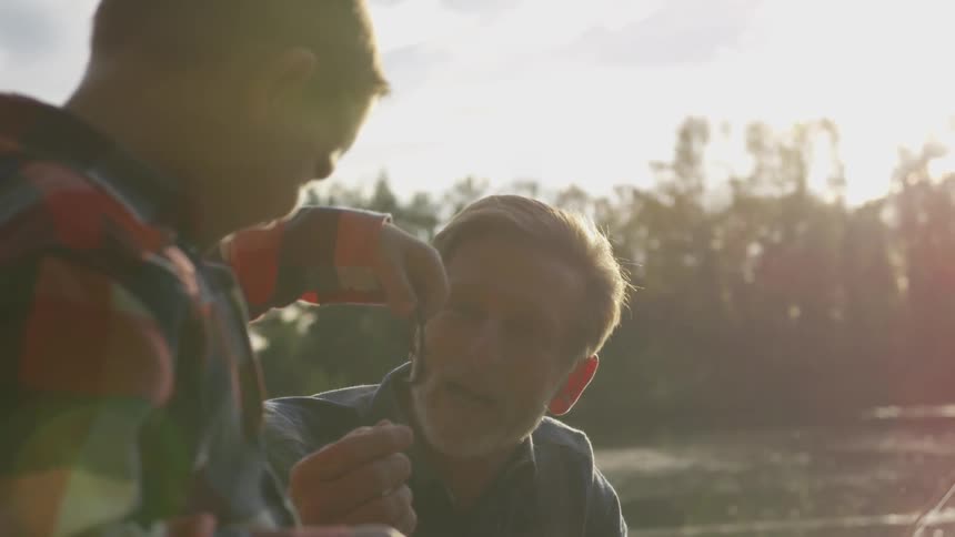 Son hold out a worm to his father