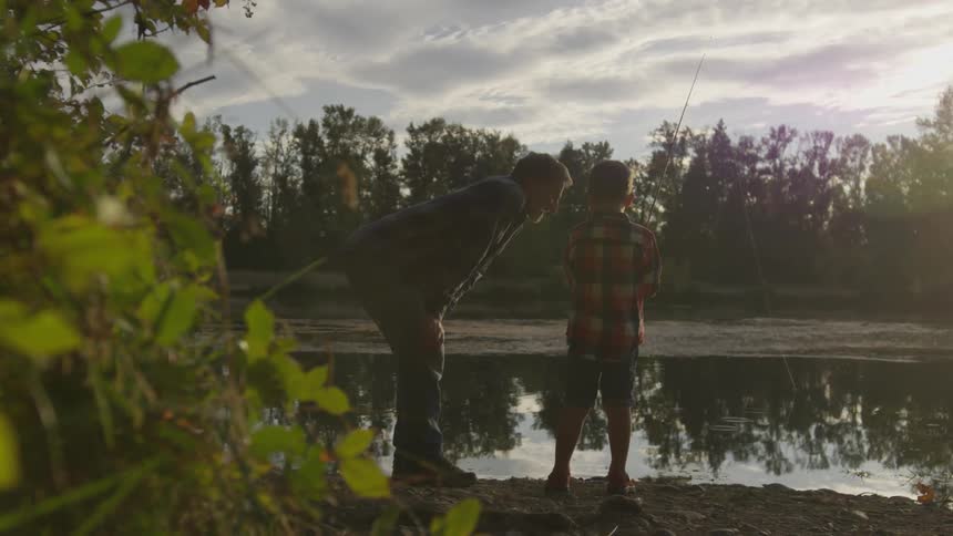 A father and son fishing by the lake