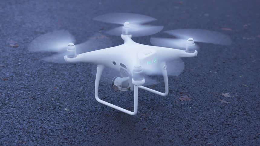 White drone getting off the ground