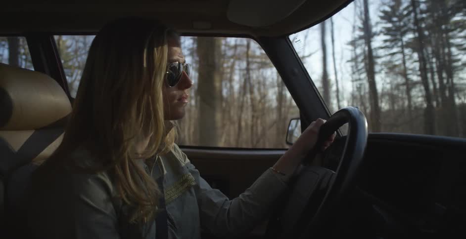 Woman driving a vehicle on a sunny day