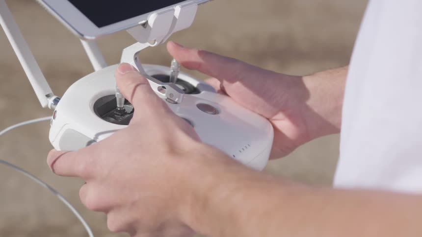 Person looks at cell phone connected to controller