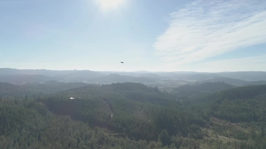 A drone flying over hilly countryside