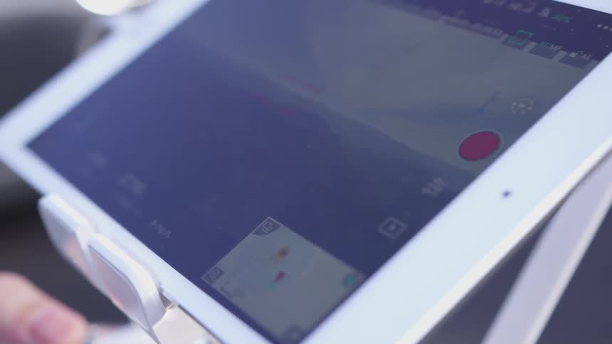 Person holds input device that hold a tablet