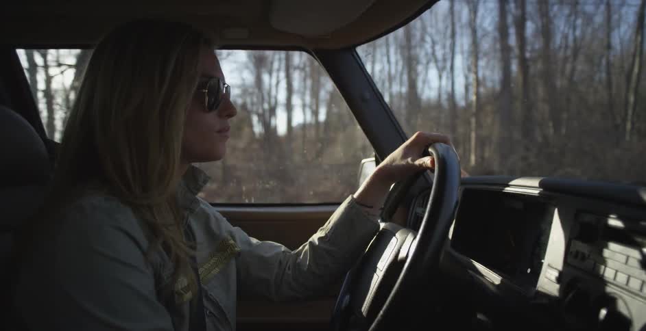 Woman driving a car on a sunny day