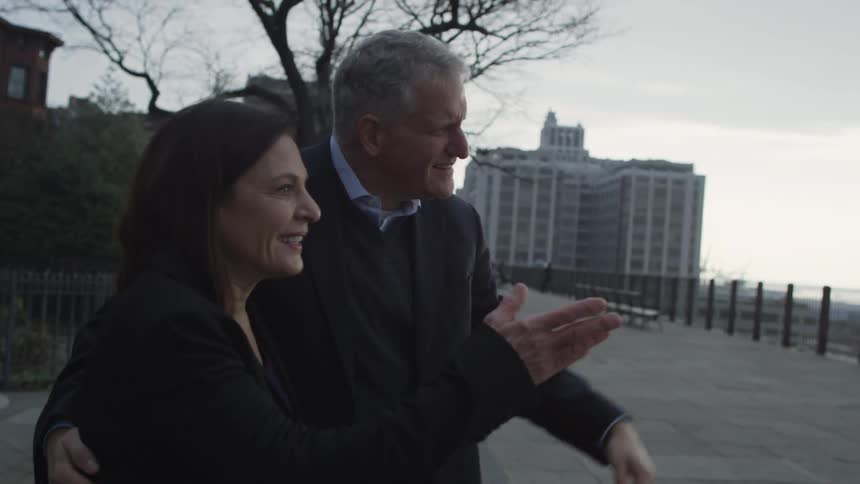 Man and woman walk outside on a cloudy day