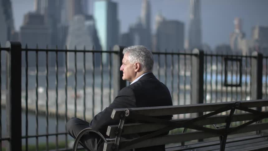 A person sitting on a city bench