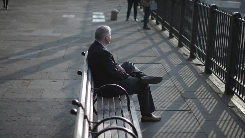 A person sitting on a city bench