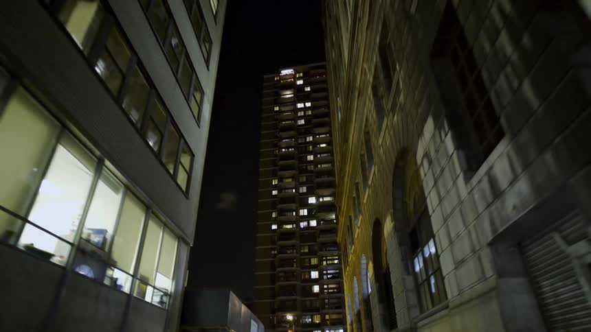 Traveling down a narrow city side street at night