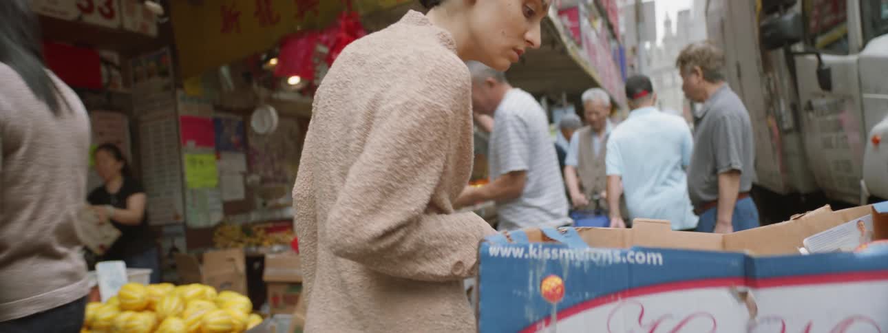 Woman walking through group at a downtown market