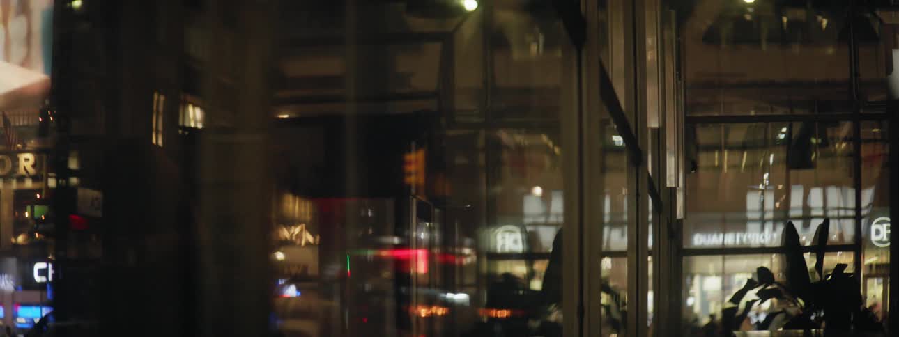 Reflection of lights and people in buildings window