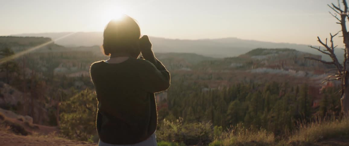 Woman Taking Photos And Exploring Overlook