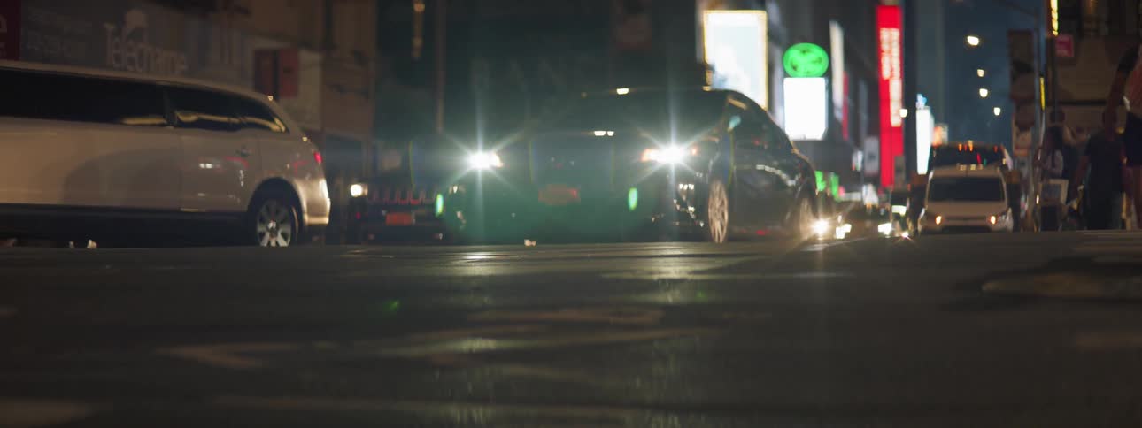 Vehicles driving down street at night