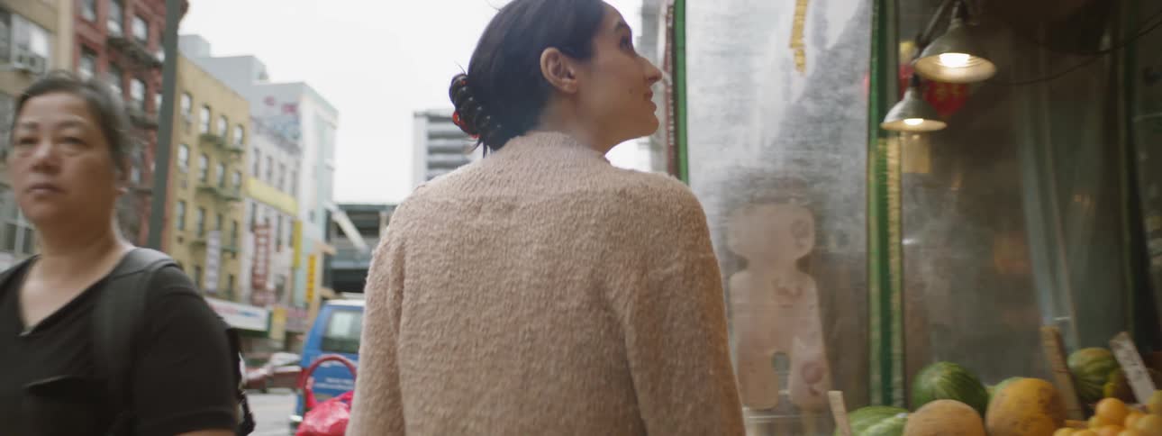 Middle eastern woman looks at food at market