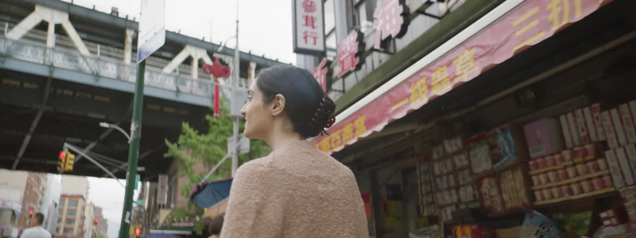 Woman smiles on a downtown street
