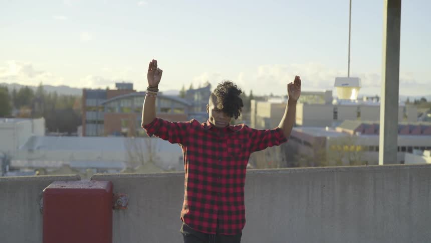 Man On Roof Of Parking Garage