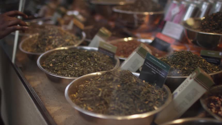 Woman shops at a spice store window display