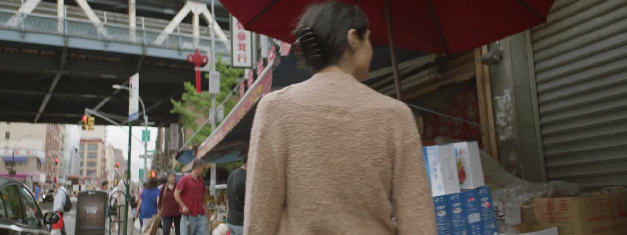 Woman looks at street market in city