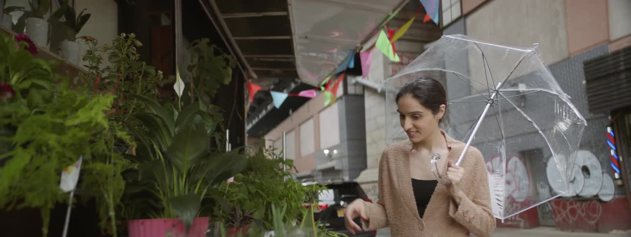 Woman looks at plant at store