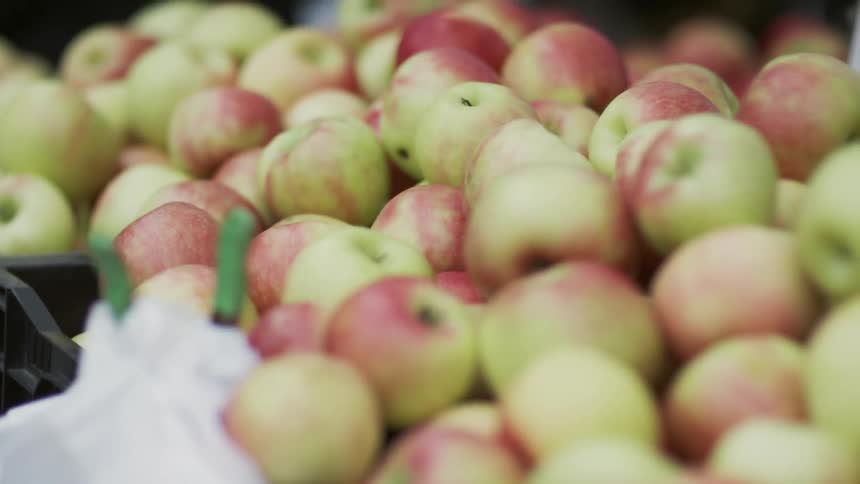 Crates of apples at an outdoor fruit stand