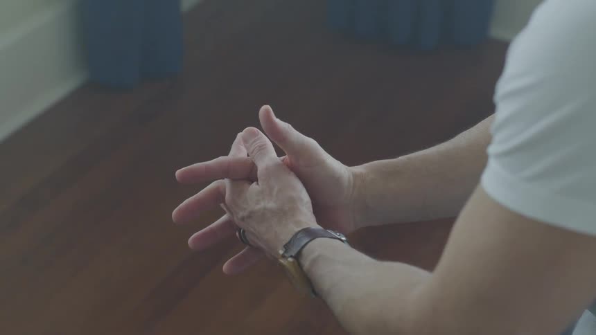 Man Sitting And Thinking On Bed