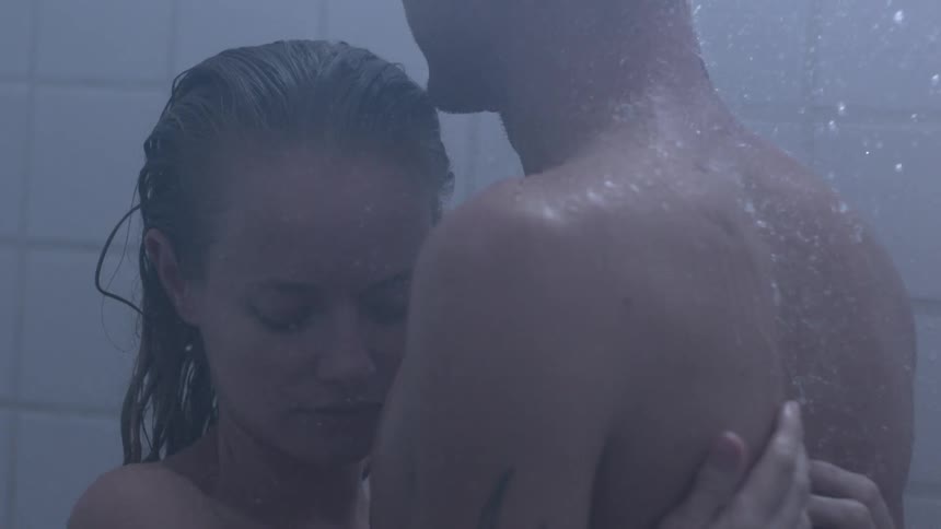 A couple embrace while showering