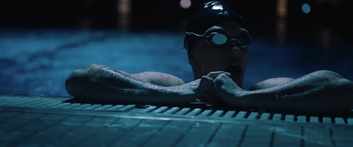 A woman resting after swimming in a pool