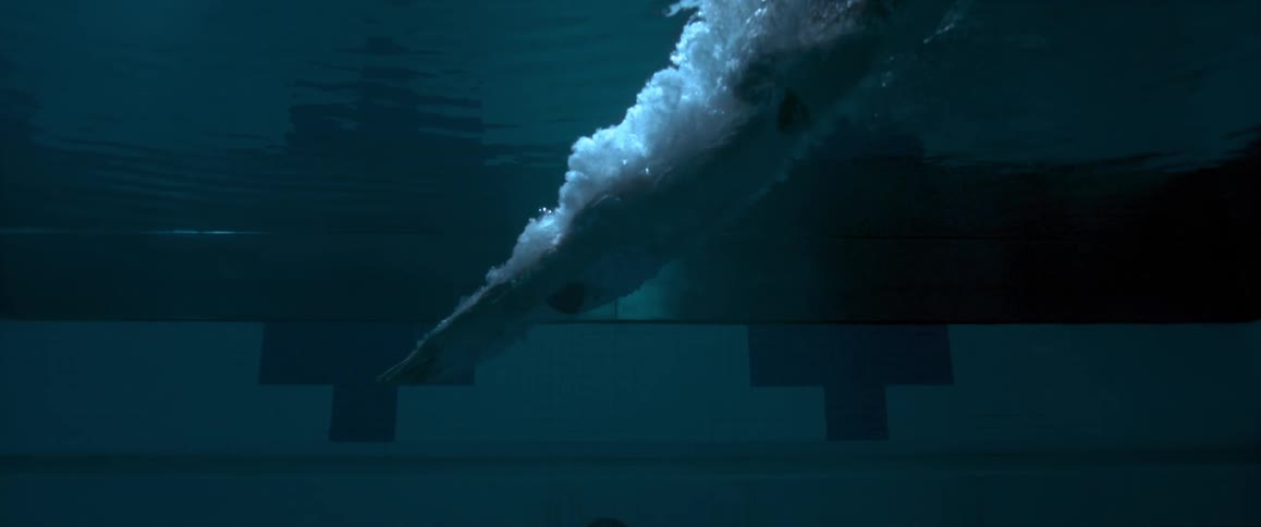A person dives into a dark pool