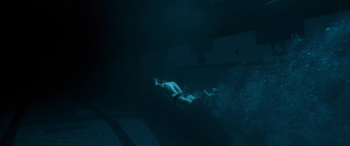 A man swimming underwater kicking his feet