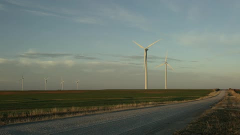 Windmills turning in an open field in the country