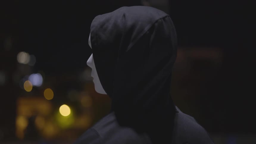 Man Wearing Mask With A Gun At Night