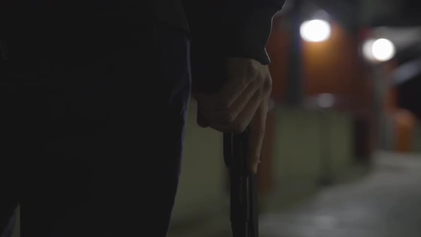Man Wearing Mask With A Gun At Night