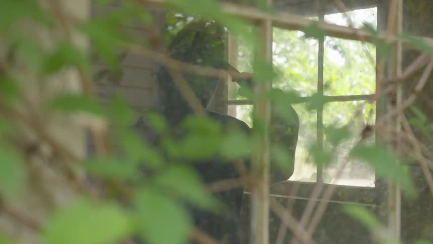 Man With Gun In Abandoned House