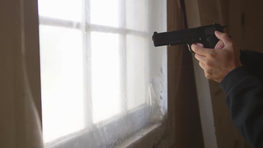 Man With Gun In Abandoned House