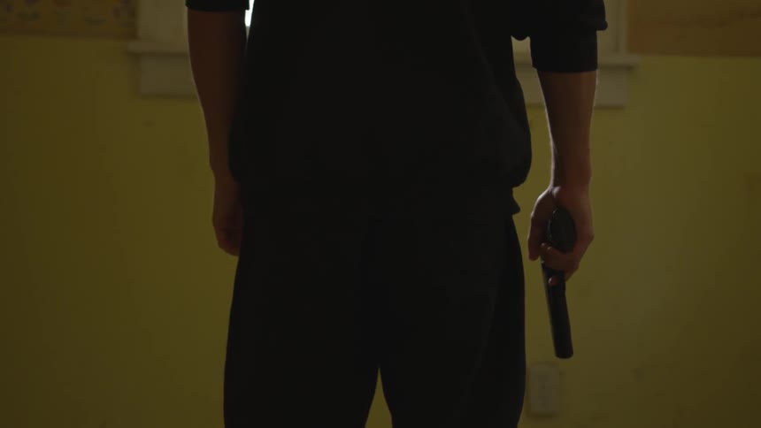 Man With Gun In Abandoned House