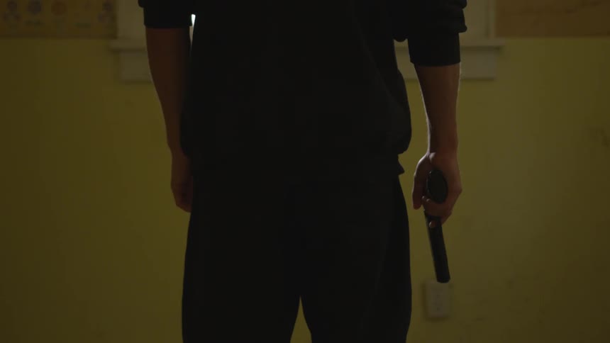 Man With Gun In Abandoned House