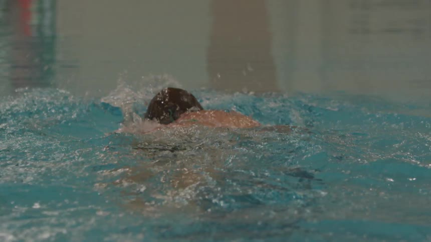 Man Swimming Laps In Indoor Pool
