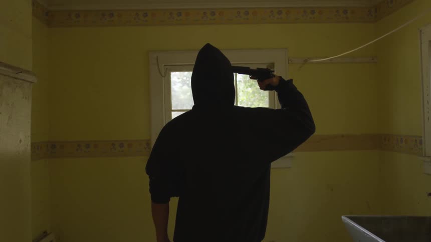 Man With Gun In Abandoned House