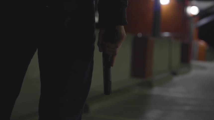 Man Wearing Mask With A Gun At Night
