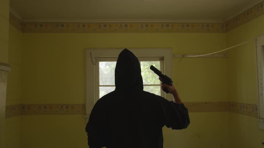 Man With Gun In Abandoned House