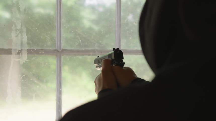 Man With Gun In Abandoned House