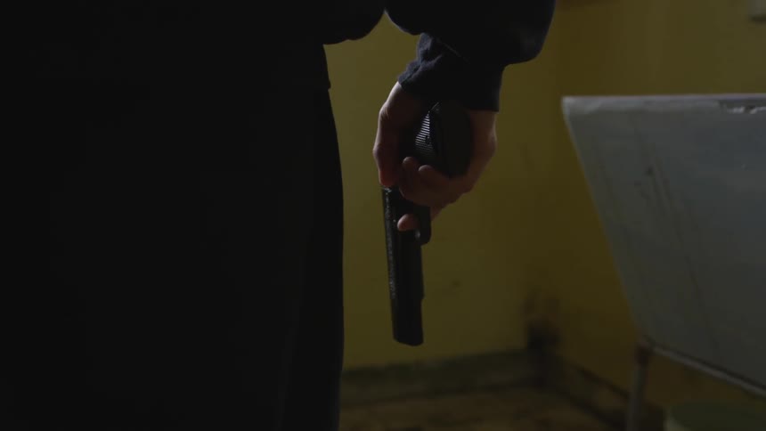 Man With Gun In Abandoned House
