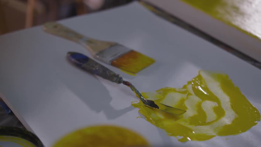 Older Man Painting In Studio