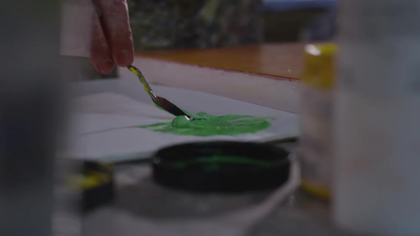 Older Man Painting In Studio