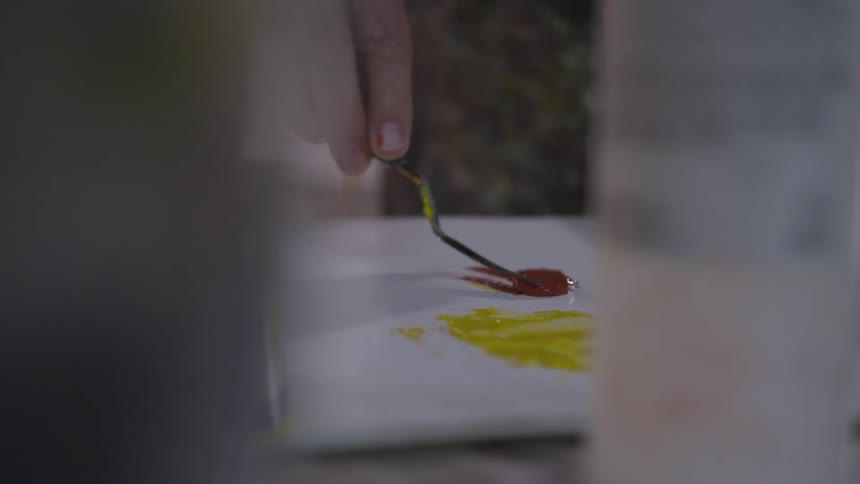 Older Man Painting In Studio