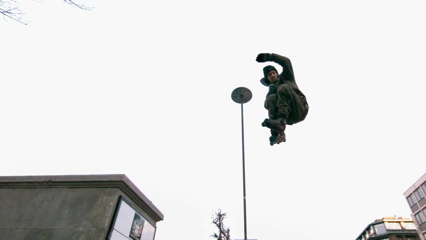 Person doing a three sixty high in the air in the city