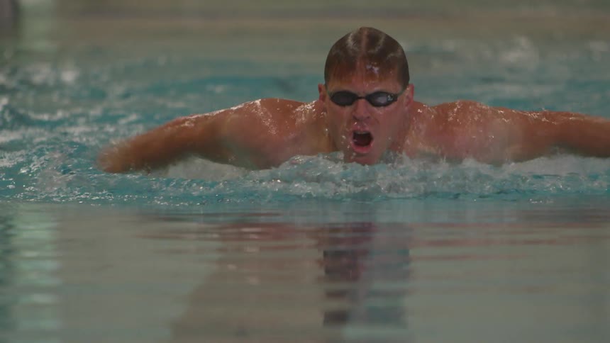 Man Swimming Laps In Indoor Pool