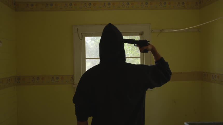 Man With Gun In Abandoned House